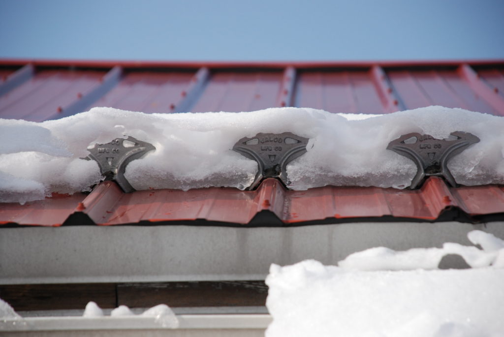 jalco snowguards red metal roof with snowguards and snow closeup